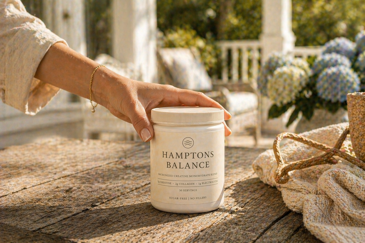 Women Hand reaching for Hamptons Balance creatine tub on Hamptons porch with hydrangeas for Daily Ritrual
